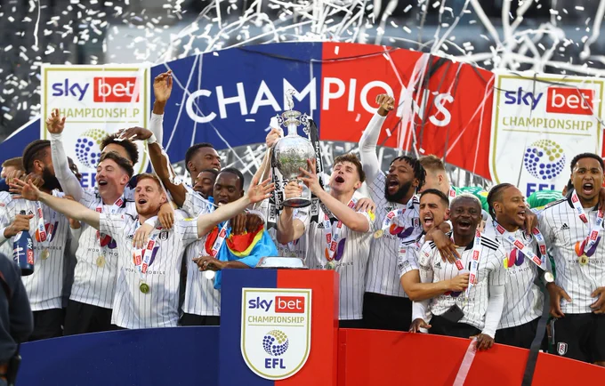 Fulham lift the Sky Bet Championship trophy. GET IN!