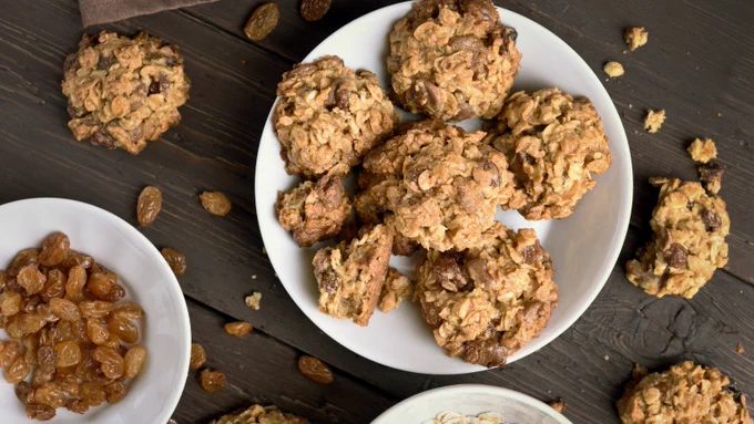 Photo of oatmeal raisin cookies and a dish full of raisins.