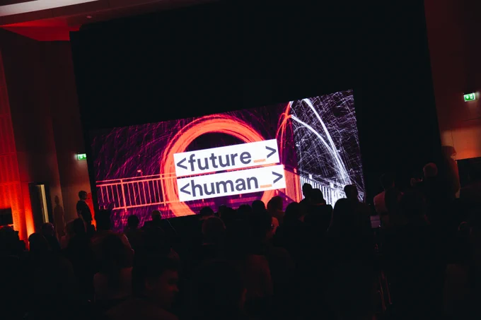 Images of live stage at Future Human with people in foreground