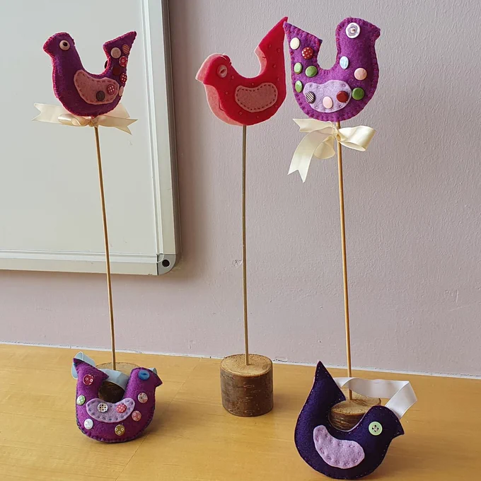 Colourful felt birds on sticks