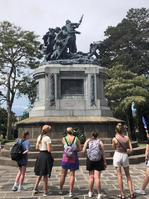 Husker students learn about a statue in a park in San Jose, Costa Rica