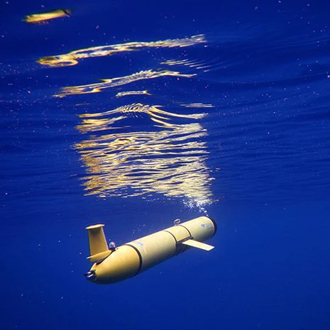 A yellow Slocum glider floats just beneath the ocean surface.
Credit: Rutgers University Center for Ocean Observing Leadership.
