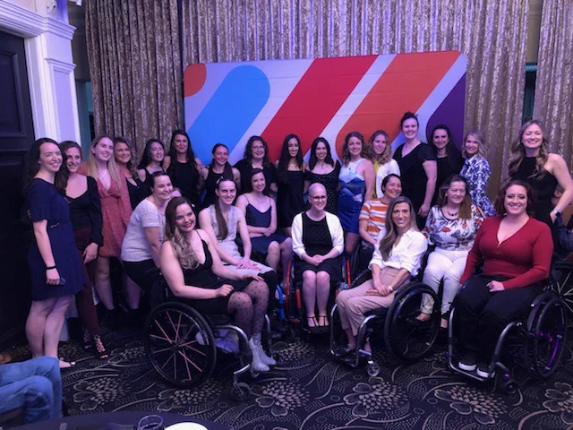 A large group photo of all of the women at the 2022 Canadian National Wheelchair Rugby Championship banquet (athletes, coaches, admin, and support staff)