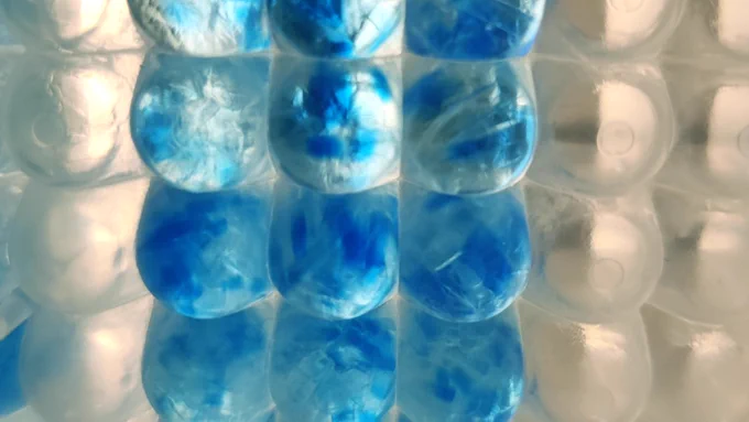 Image submitted by Dr. Aicha Asma Houfani to the CBR Cover Art Contest, April 2022: protein corona in a well plate, which looks like blue circles in a well plate