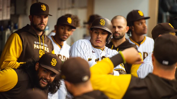 A group of Padres players posing for a photo after Manny Machado's home run.
