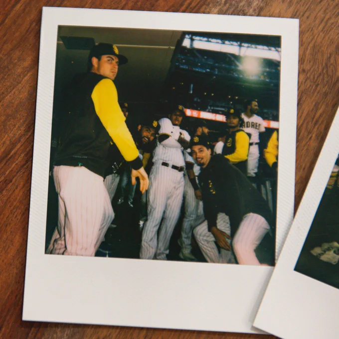 A photo of a Polaroid of a group of Padres players posing after Manny Machado's home run.