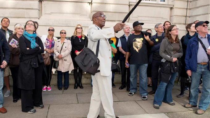 A man leads a group of people on a tour.