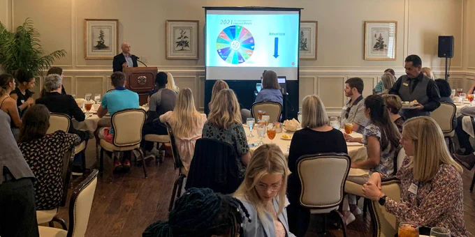 Guy Golan, a TCU strategic communication professor, stands at a podium delivering his remarks at the Fort Worth PRSA luncheon on May 4, 2022. 