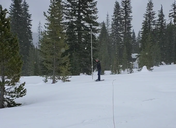 Brock Phillips, USBR Physical Scientist, prepares to take a snow core sample along the Park H.Q. Snow Course in Crater Lake National Park. Snowpack at the site was 69% of median. (Photo taken April 28, 2022: Chris Gebauer, NRCS Soil Scientist)