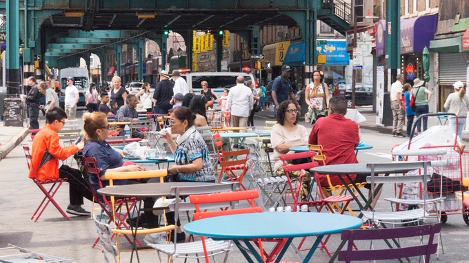 A public space with people sitting at tables.