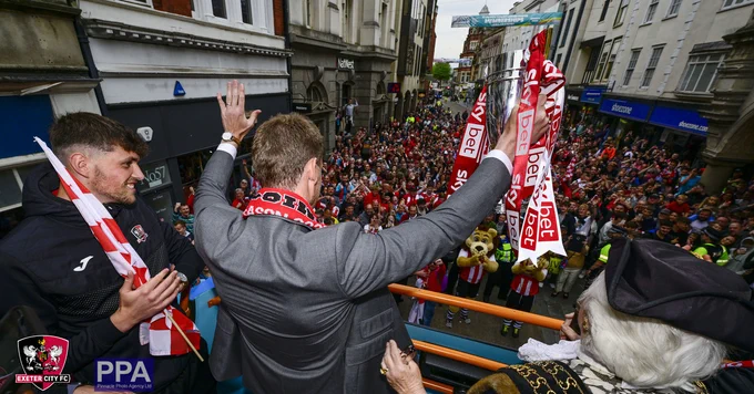 Matt Taylor salutes supporters after guiding Exeter City to League One.