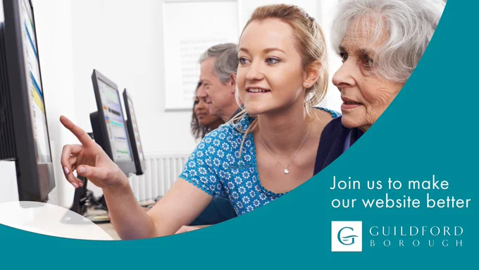 Two ladies pointing at computer screen
