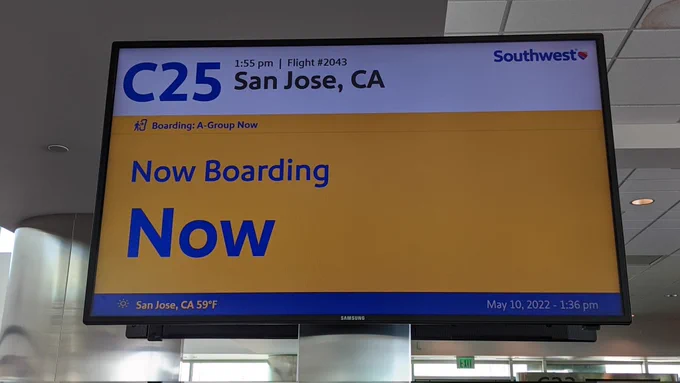 Airport monitor showing Southwest Airlines flight to San Jose CA now boarding