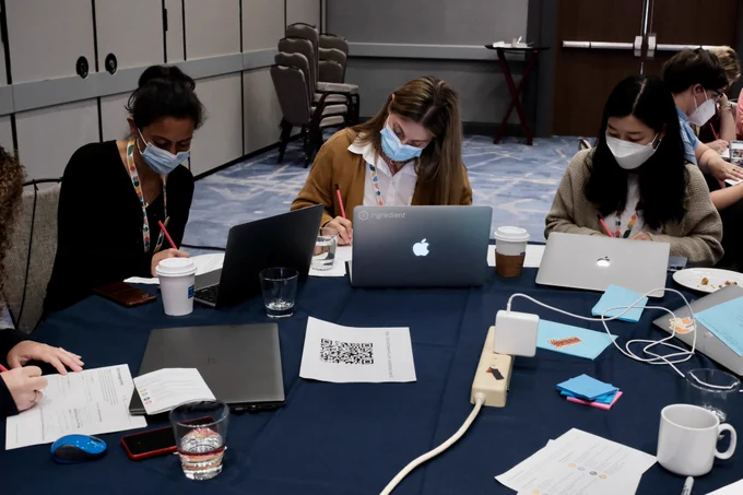 Attendees work on a hands-on exercise at their table.