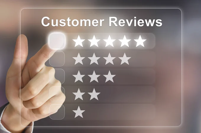 Hand making a five-star review