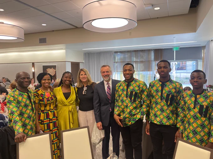 Dr. Corey posing with wife and family of Virtue's during a graduation reception.