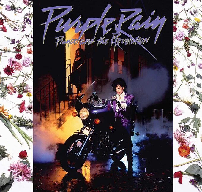 Prince seated on his motorcycle in a city at night