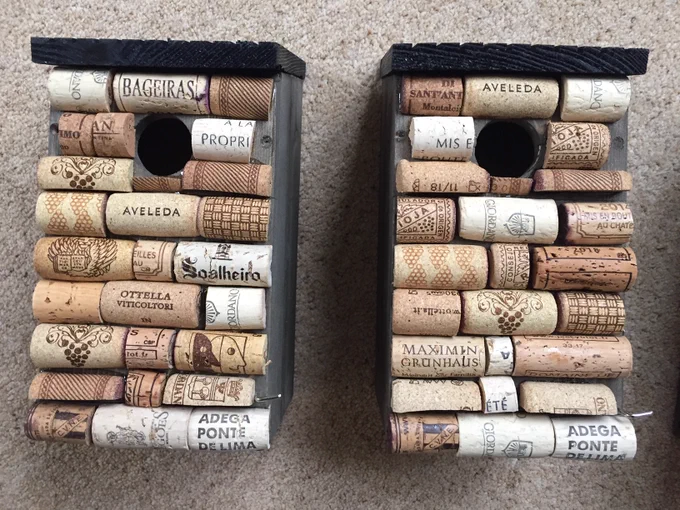 This image shows two birdhouses made out of corks from wine bottles