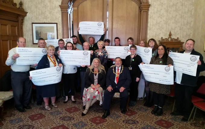 A picture of the Mayor and Mayoress with some of those receiving cheques from the Mayor's Community Fund at the Town Hall.