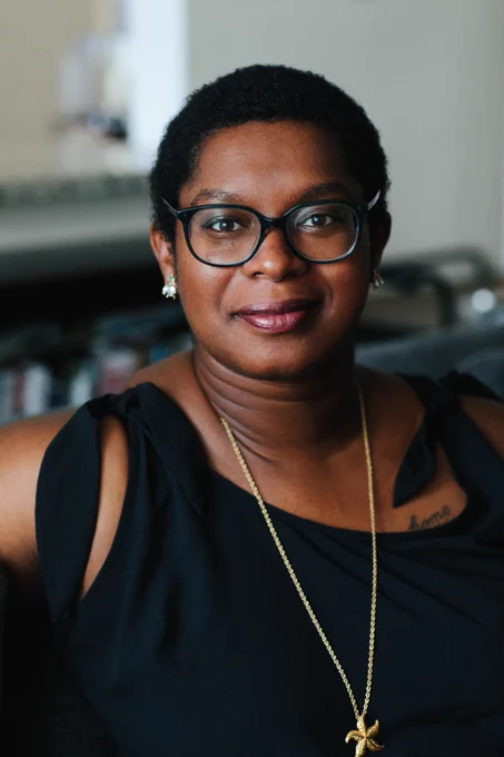 Headshot of Ashley C Ford in a black top and glasses