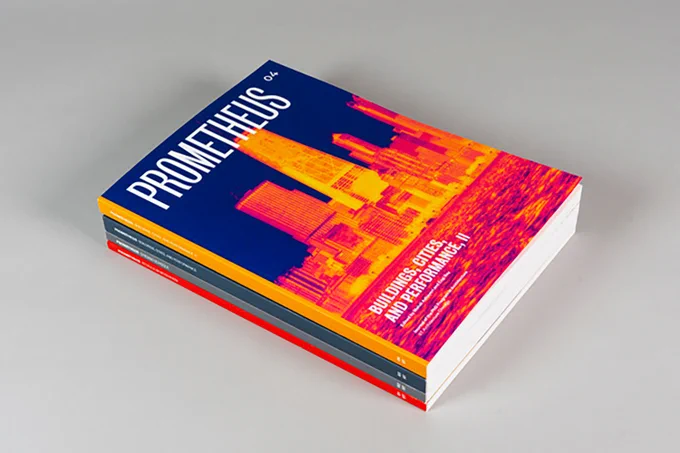A stack of four magazines, with the top one titled  "Promotheus" and featuring a city skyline illustration in orange with a dark blue sky in the background