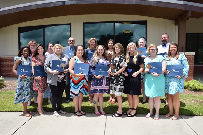 Photo Caption: Front Row: (left to right): Markeita Barber, Pine Tree Hill Elementary School; Valerie West, Camden Elementary School; Kara Matney, Stover Middle School; Michelle Johnson, Stover Middle School; Lynley Jones-Blankenship, Continuous Learning Center; Wendy Blair, District Office; Nicole Kirkley, Blaney Elementary School; Abby Spitzer, North Central Elementary School; and Heather Jackson, Pine Tree Hill Elementary School. Back Row (left to right) Beth Jeffers, Camden Elementary School; Emily Baccomo, Lugoff-Elgin Middle School; Gene Cameron, Lugoff-Elgin Middle School; Mary Anne Byrd, District Office; Nicky Templar, District Office; Julie Putnam, District Office and Britt Gardner, North Central Elementary School.  Not pictured: Matia Goodwin, Camden Elementary School and Robin Sowell, North Central Elementary School.  #myKCSD