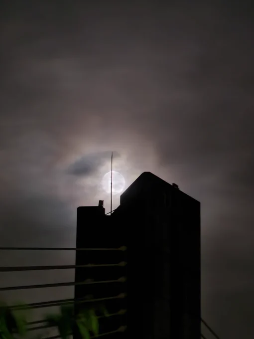 A close up of the top of a bridge tower silhouetted against the moon at night, composed to look like the Eye of Sauron as was visually depicted in the movie adaptation.