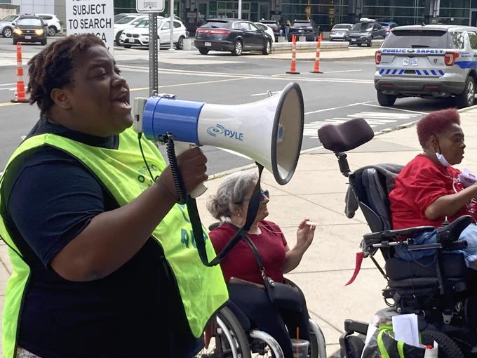 A group of ADAPTers, one of whom is holding a megaphone