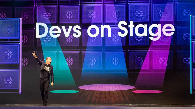 Tableau Chief Product Officer on stage during Tableau Conference keynote in front of sign that says "Devs On Stage."