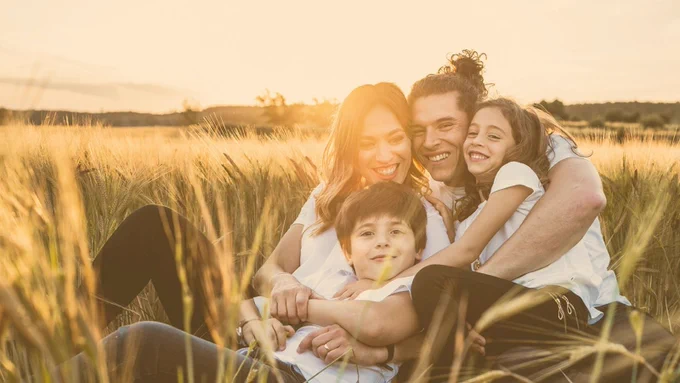 Smiling family in a field