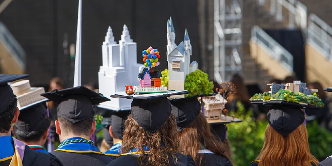 3-D structures of the house from Disney Pixar's "Up," New York City's El Dorado building, and Neuschwanstein Castle in Germany on top of mortarboard graduation caps.