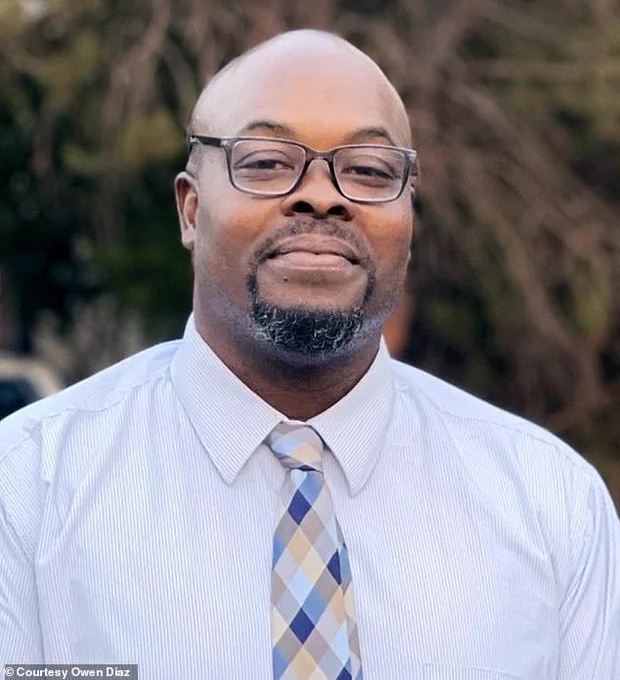 Man with glasses, goatee, and white shirt and tie.