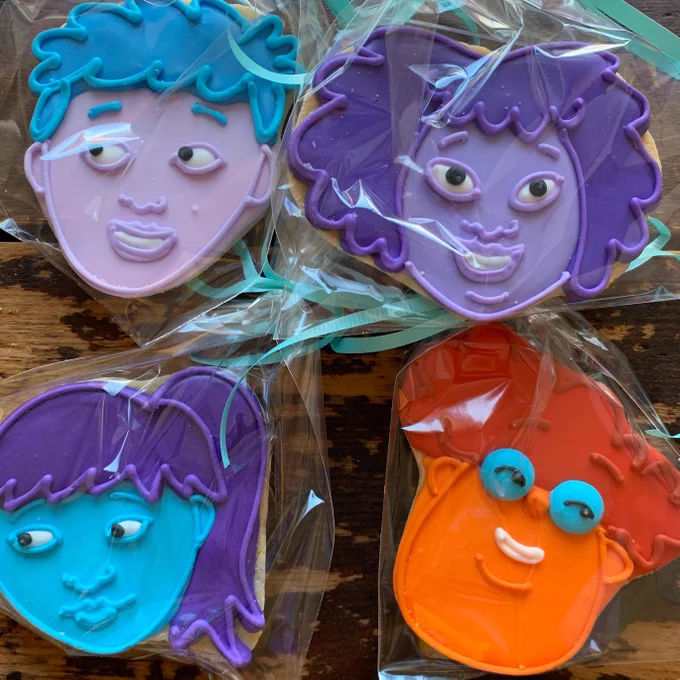 Four sugar cookies decorated to look like the faces of the four characters from You Know, Sex. 