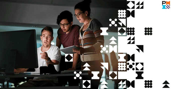 three people leaning over a computer screen and having a discussion