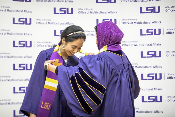 A graduate receives a cloth at the Multicultural Celebration.