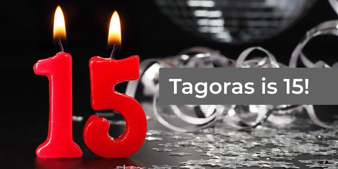 Lit red candles in the shape of a 1 and a 5 and the message Tagoras is 15 against a black and white backdrop with curled ribbon and stars on a table. 