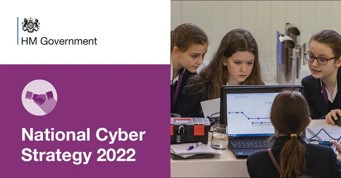 An image of young women at computers;
The text reads HM Government, National Cyber Strategy 2022 on a white and purple background