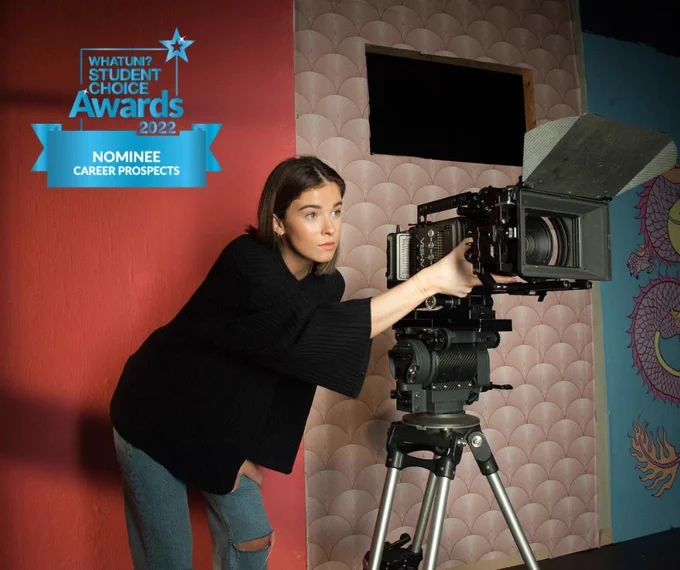 Film production student at university of Gloucestershire with camera, What Uni Awards logo in corner