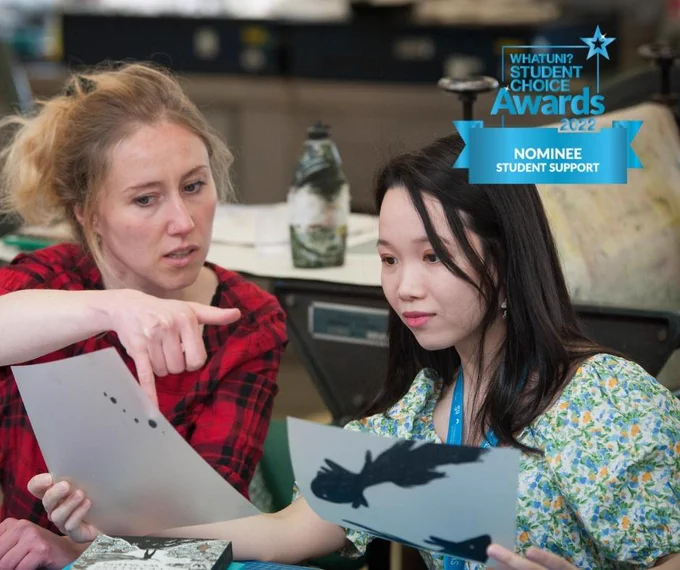 Illustration students at University of Gloucestershire with paper in hand, What Uni Awards logo in corner.