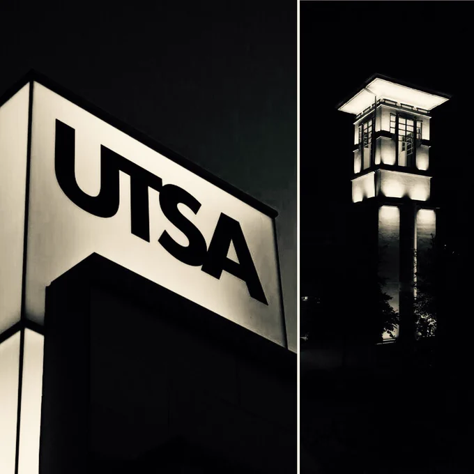 The UTSA Monument and Student Union tower are lit in white. 