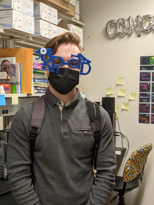 Eli sporting graduation glasses to celebrate his successful defense.