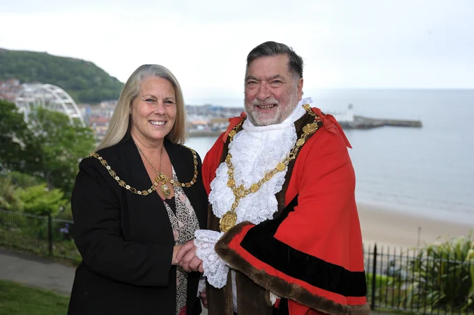 Picture of the Mayor and Mayoress of the borough of Scarborough, against the backdrop of Scarborough South Bay.