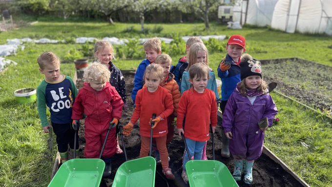 Squirrel Scouts using wheelbarrows