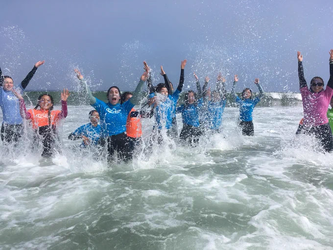 children enjoying the waves at the beach