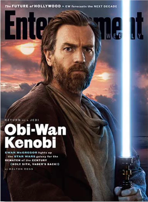 The April 2022 cover of Entertainment Weekly magazine, with Ewan McGregor as Obi-Wan Kenobi. He has a full beard and holds his blue light saber, set against the backdrop of Tatooine's two suns.