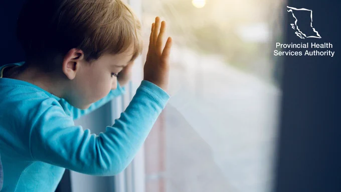 Child looking out a window.
