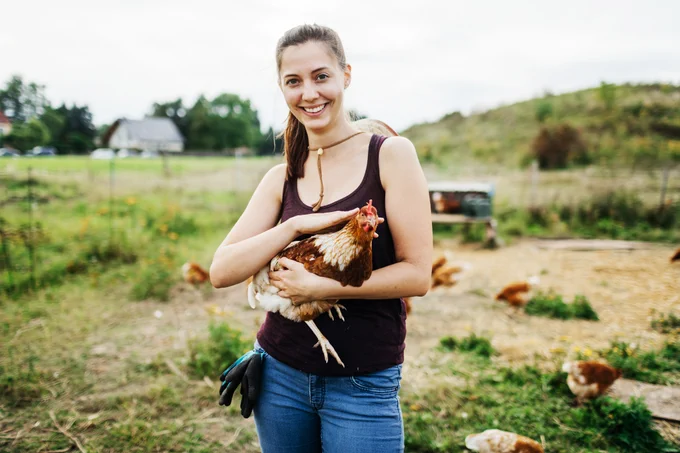 Woman holding a chicken