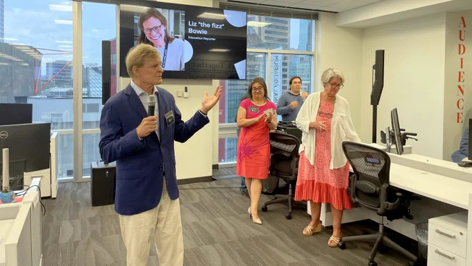 Stewart Bainum speaks to guests at the new Baltimore Banner office, as editor in chief Kimi Yoshino and Lynn Venetoulis listen. (Fern Shen)