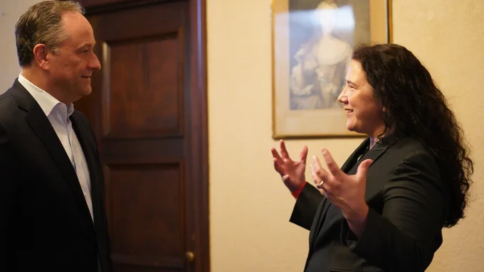 Two people standing indoors.
