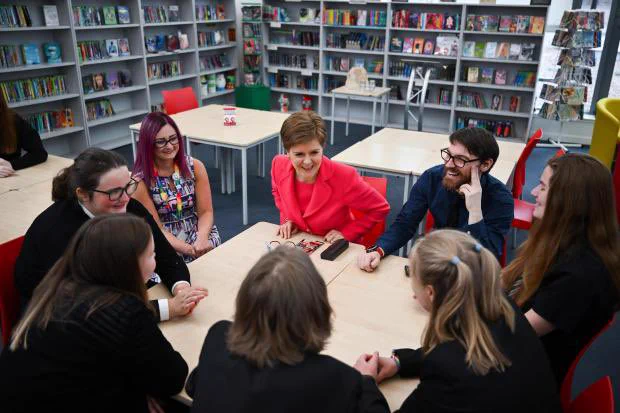 First Minister Nicola Sturgeon talking to school librarians and students in Prestwick Academy Library. Photo from the Daily Record.